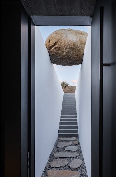 Aimasia Villa mykonos greece interiors rock stone boulder suspended over staircase