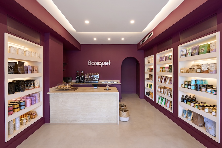 Basquet wellness-centric online grocery brand miami store burgundy paint grocery aisle shelving sculptural wall niche