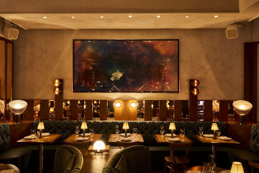 The Dynamo Room new york manhattan steakhouse penn station satellite light fixtures custom pattern banquettes table lamps mirrored walls sconces wall art peter bradley acrylic paintings