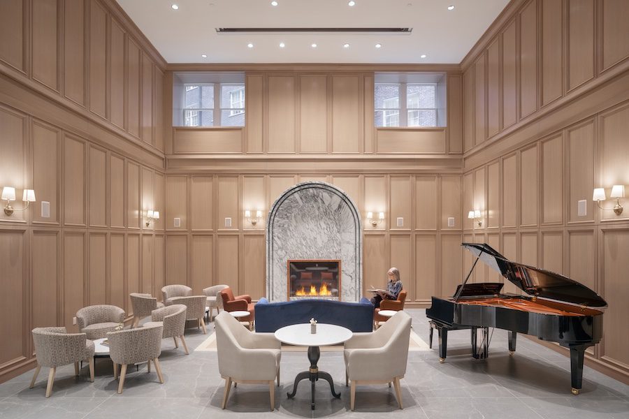 inspir embassy row washington dc senior living housing assisted living facility adaptive reuse gathering room paneled walls fireplace grand piano