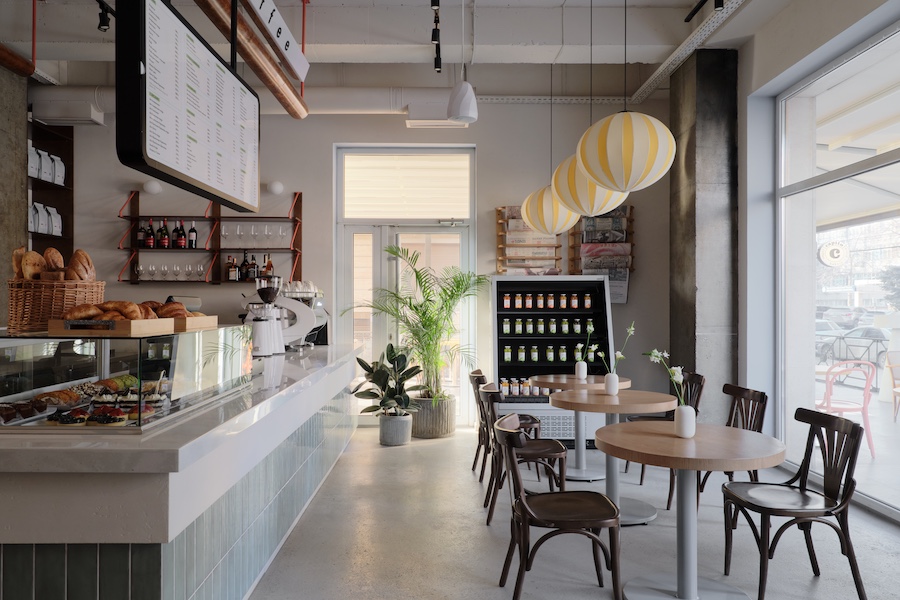 Capito Café Bishkek Kyrgyzstan industrial loft raw concrete walls exposed pipes yellow white lantern lights