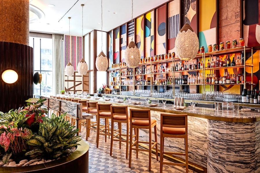 Marcus DC Restaurant Washington Marcus Samuelsson union market african diaspora colorful wall art collage marble bar stools