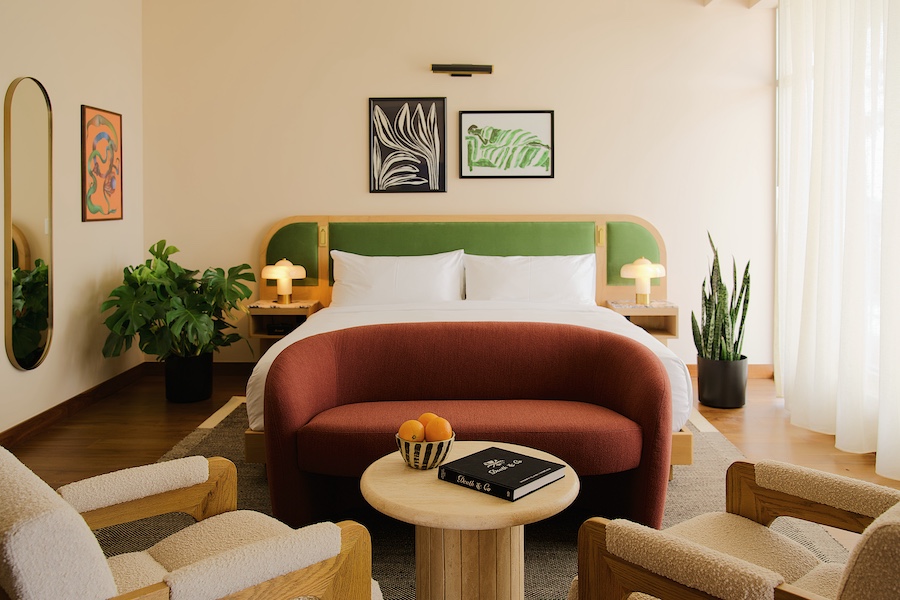 Municipal Grand midnight auteur savannah georgia midcentury design guestroom bed red curved sofa