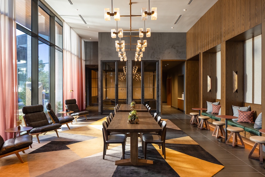 The Clara residences silicon valley california parkside lounge meeting table wood orange black carpet