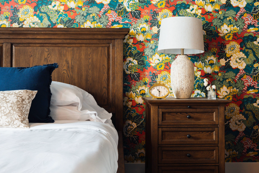 the painted lady birmingham alabama lark hotels guestroom floral wallpaper wood headboard nightstand lamp